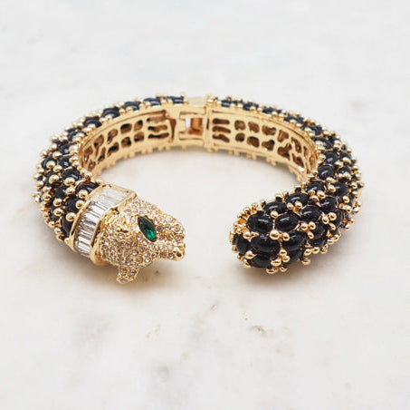 NIIKI PARIS Jonc leo noir et marron à une tête ( poignet 17 cm) Tout les bijoux NIIKI indisponibles sont en précommande dans un délai de 15 jours ouvrables voir en privé avec Laetitia .