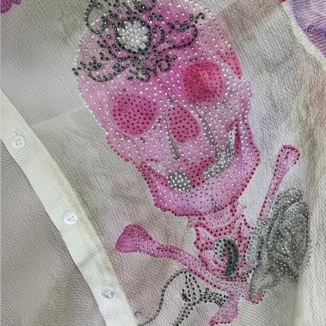 Chemise artistique 409 – chemisier femme Missy en voile transparent, motifs de crânes stylisés roses et violets, strass et paillettes, coupe fluide à col classique pour un look rock chic