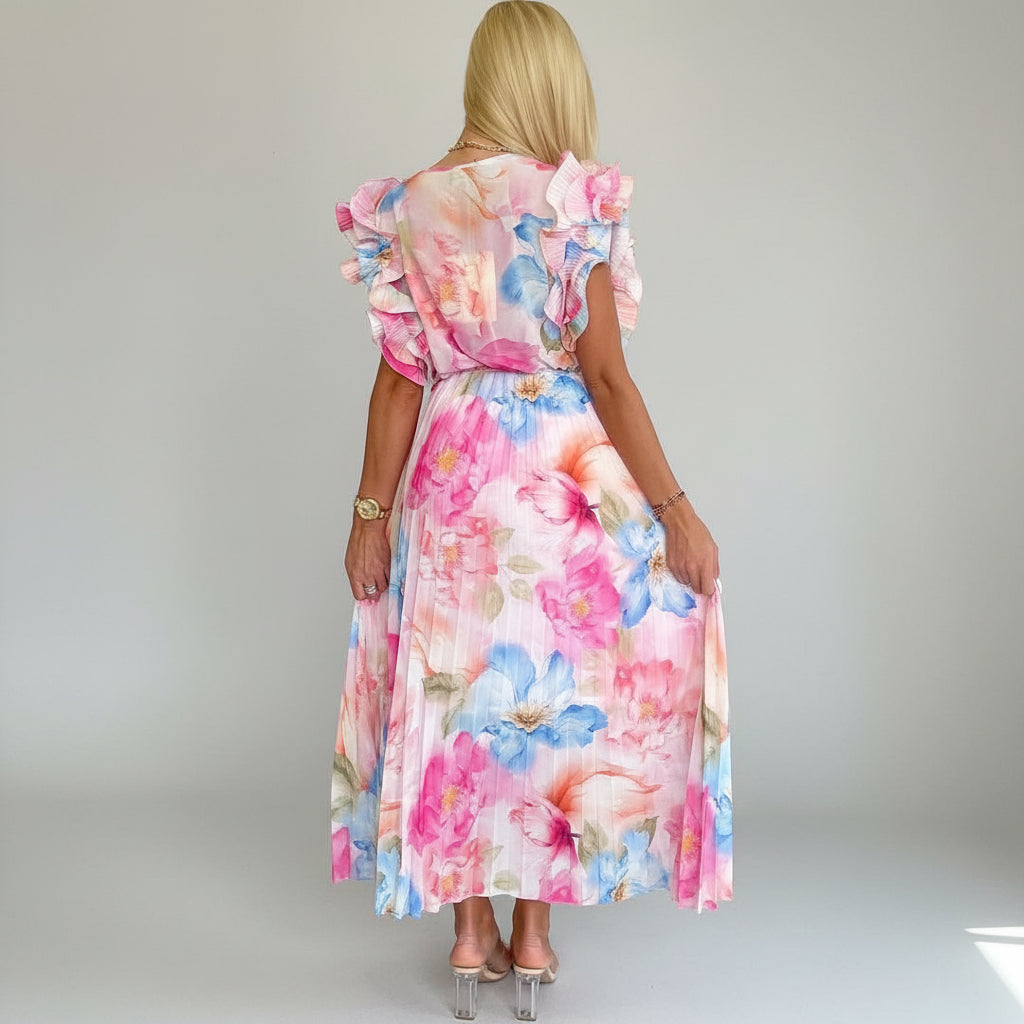 PAPARAZZI robe longue plissée à fleurs 2142  : l’élégance vaporeuse en mousseline pour vos soirées d’été, avec son décolleté en v plongeant et ses manches à volants, une pièce unique pour un look romantique et sophistiqué.
